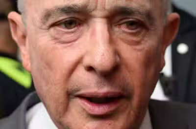 Colombian former President Alvaro Uribe gestures as he speaks to the press outside a court complex at the end of his trial in Bogota on February 10, 2025. The oral trial against former Colombian president Alvaro Uribe for procedural fraud and witness tampering began on February 6, 2025, despite requests from the defense to postpone what is the last stage in the historic criminal trial before the verdict. (Photo by Raul ARBOLEDA / AFP)