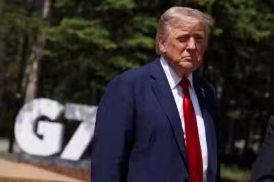 US President Donald Trump speaks to reporters with the British prime minister (out of frame) during the Group of Seven (G7) Summit at the Pomeroy Kananaskis Mountain Lodge in Kananaskis, Alberta, Canada on June 16, 2025. US President Donald Trump was leaving a Group of Seven summit early on Monday as he hinted of greater involvement in the Israel-Iran conflict after issuing an ominous warning for the capital Tehran to evacuate. (Photo by Suzanne Plunkett / POOL / AFP)